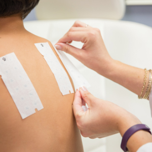 Dermatologist applying a skin allergy test to young patients back at Saguaro Dermatology in Phoenix, AZ