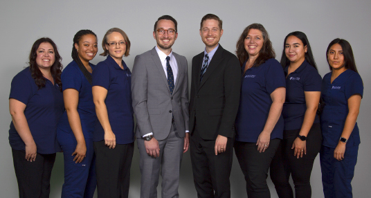 Dr. Dathan Hamann and the Saguaro Dermatology Team smiling for a group photo in their Phoenix office