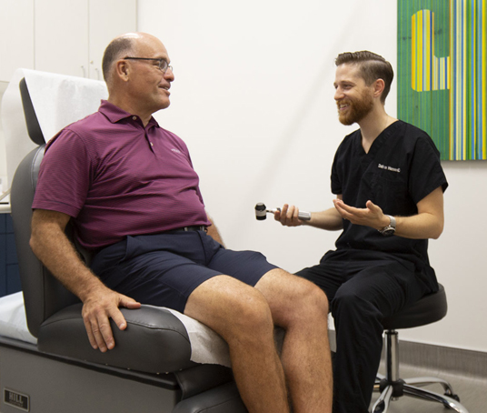 Dathan Hamann, MD, discusses with a patient