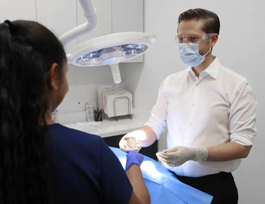 Dathan Hamann, MD with a patient at Saguaro Dermatology Surgery Clinic