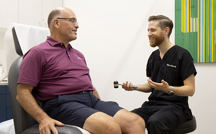 Dathan Hamann, MD, discusses with a patient